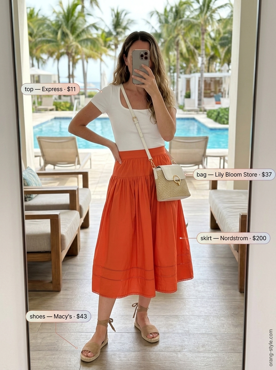 Chic coastal summer beach outfit for women 2026: Terracotta midi skirt, white crop top, gold hoops, and espadrilles.