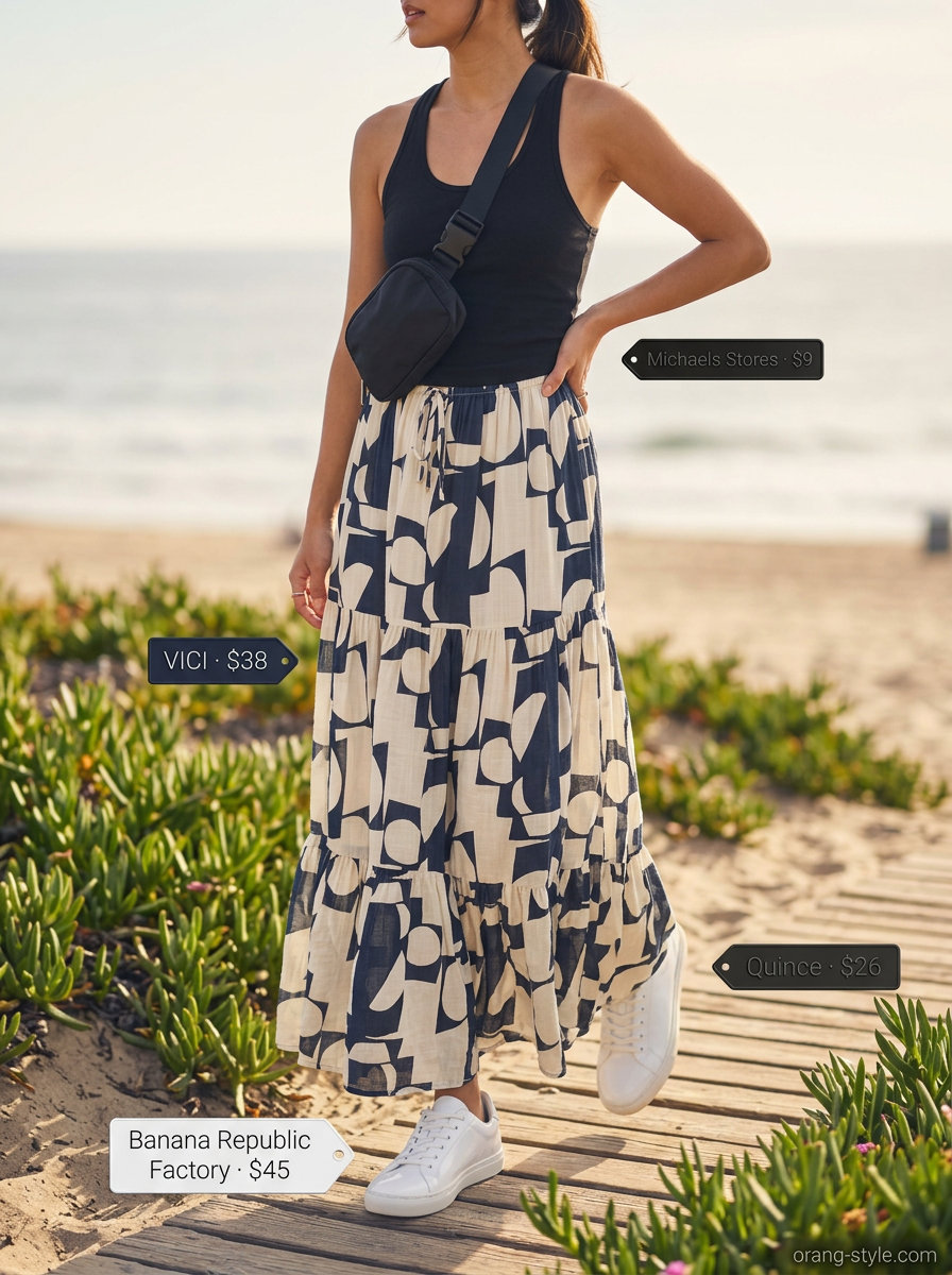 Sporty chic tiered maxi skirt outfit summer 2026: Graphic print skirt, black tank, white sneakers. Modern for active days.
