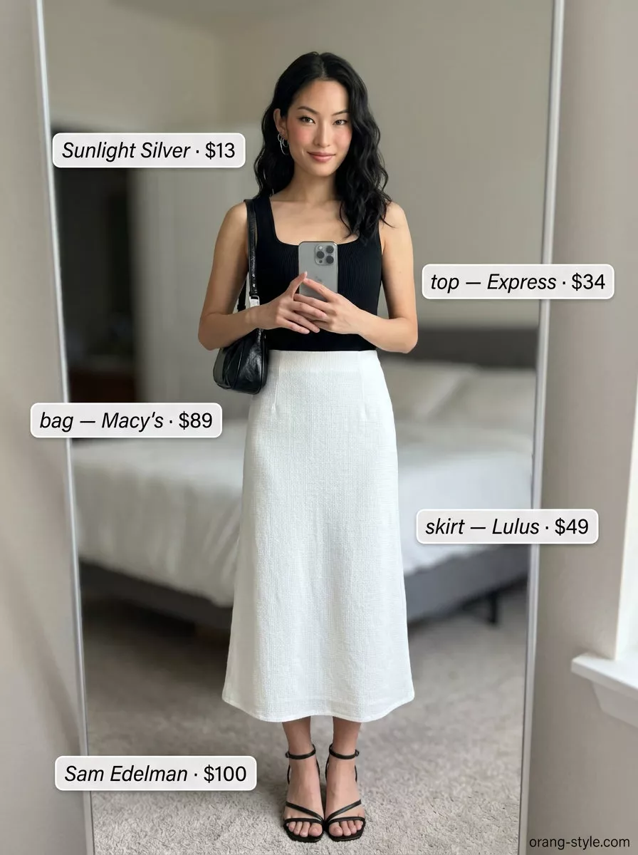 Elegant minimalist summer outfit: white A-line skirt, black tank, and silver accessories for a luncheon.