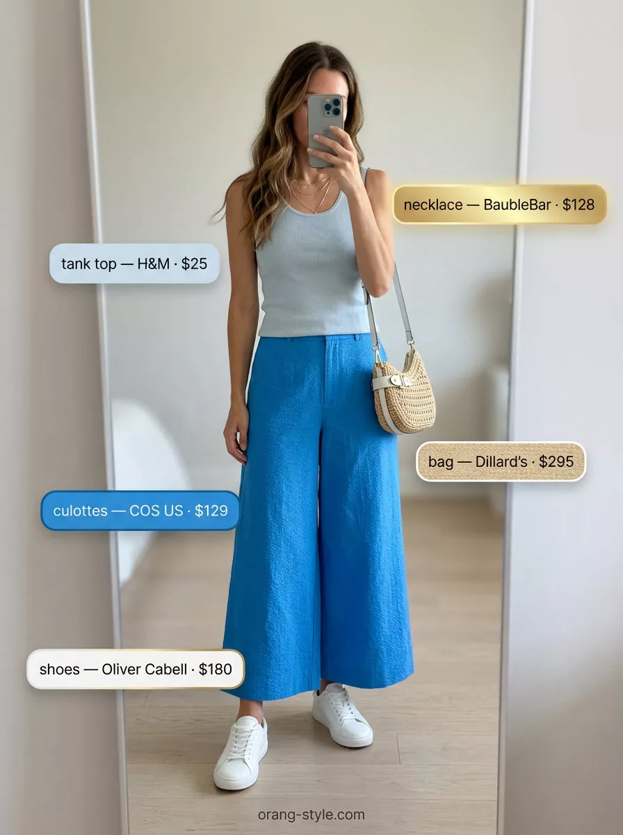 Effortless summer outfit: pastel blue culottes, matching knit top, straw crossbody, and white sneakers.