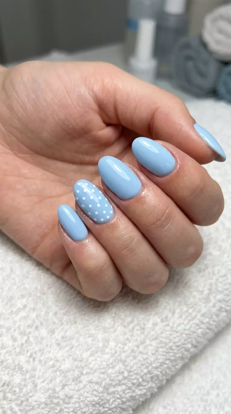 Almond Summer Nails 2026: Baby Blue Polka Dot Fun Almond summer nails 2026 for fair skin: Baby blue with white polka dots for casual wear.