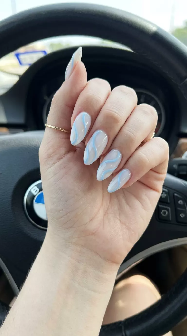 Almond Summer Nails 2026: Baby Blue Swirls Whimsy Almond summer nails 2026 for fair skin: Baby blue swirls with 3D effect for festivals.