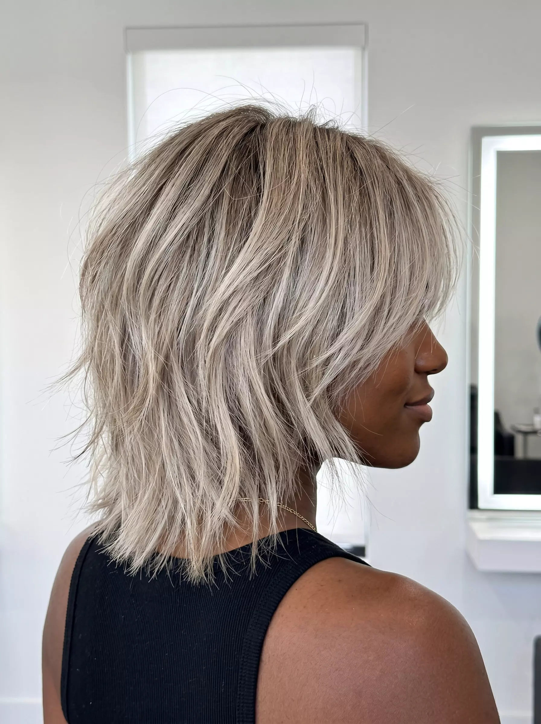 Ash Blonde Shag Haircut 2026 short ash blonde shag haircut with choppy layers and cool beige highlights for an edgy look