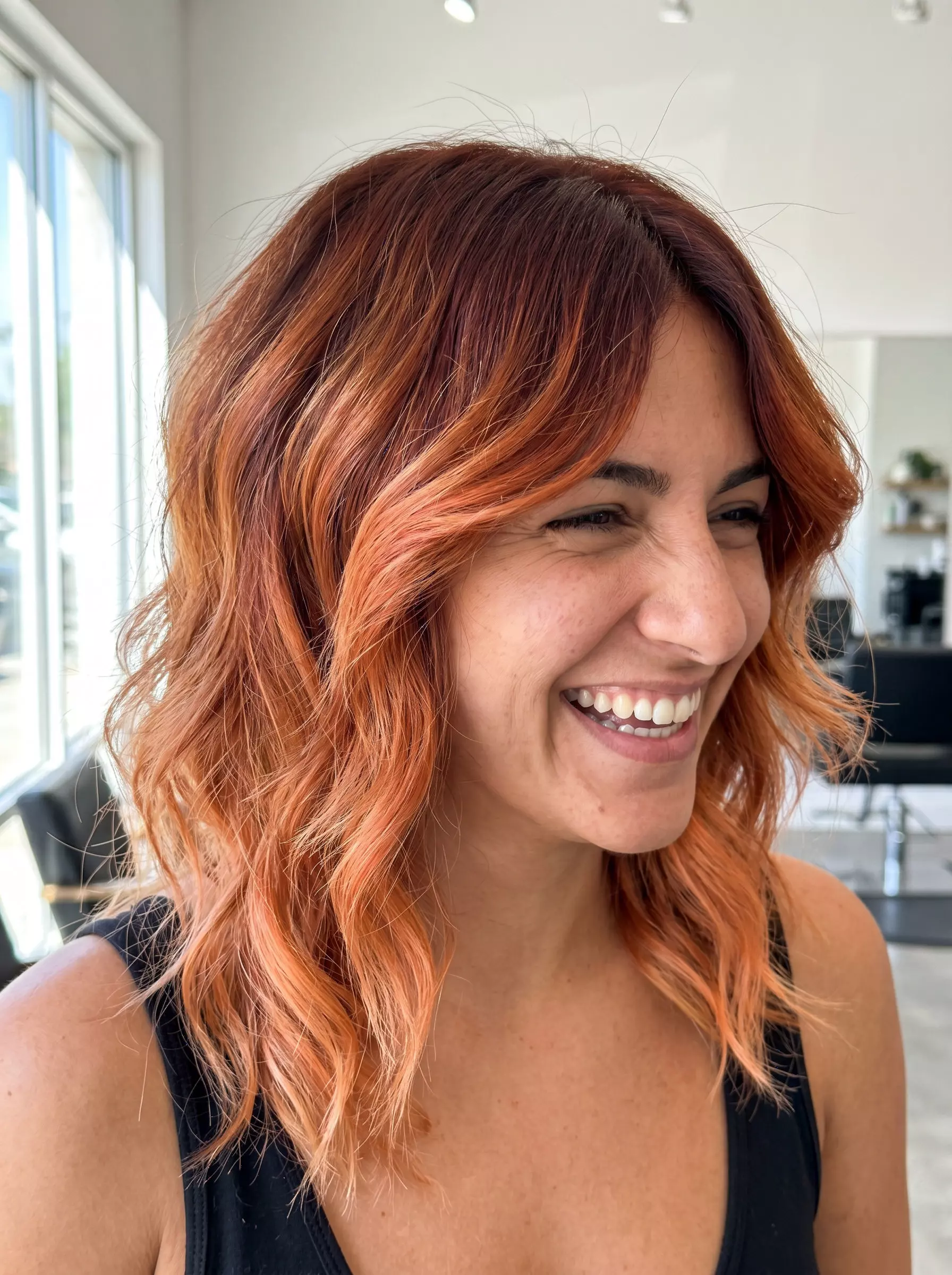 long shag haircut ombre with auburn to fiery peach, choppy layers, wispy Birkin bangs &mdash; retro and warm for summer