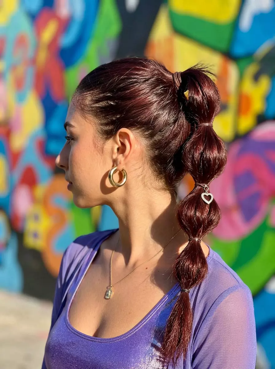 Bubble Pop Ponytail 2026 long cherry cola bubble ponytail with violet undertones, layered cut, no fringe — playful concert look