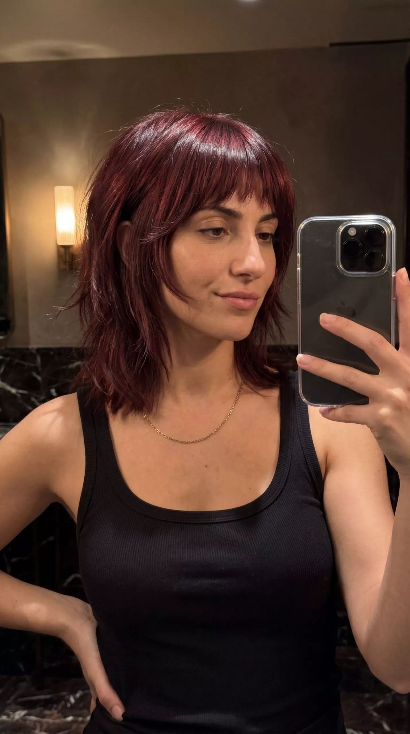 mid-length shag haircut in cherry cola red with violet undertones, razor cut layers, choppy fringe &mdash; edgy summer vibes