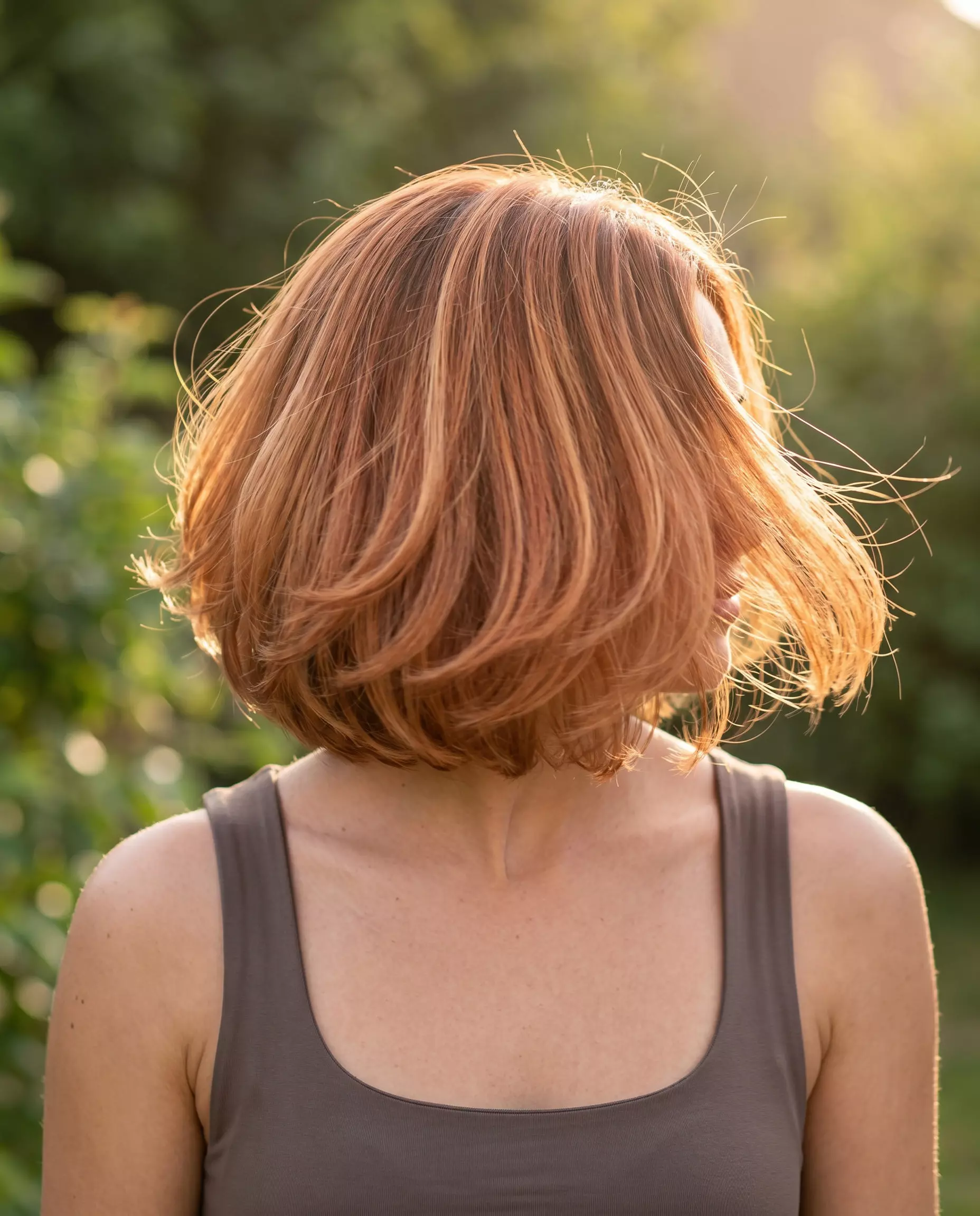 Sun-Kissed Copper Wave Bob 2026 short copper balayage bob haircut with strawberry blonde highlights and soft waves for summer