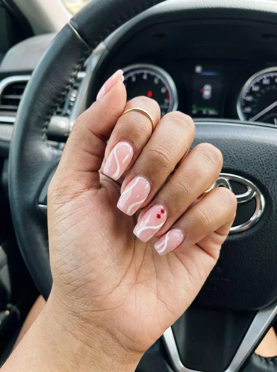 Creamy Pink Swirls Strawberry Detail nails: Bohemian art with soft white swirls and subtle red dots.
