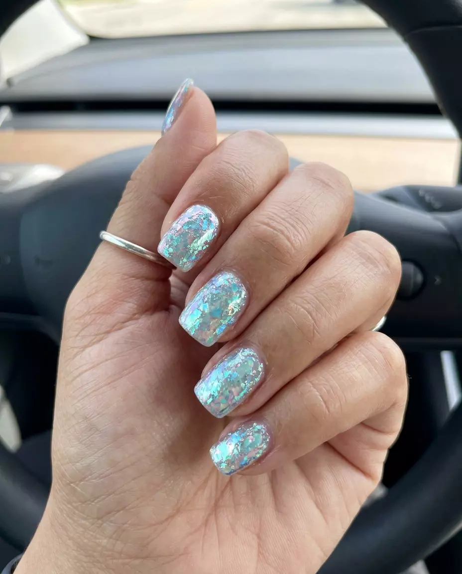 Cute summer nails 2026: Shimmering iridescent foil flakes on square nails for festivals.
