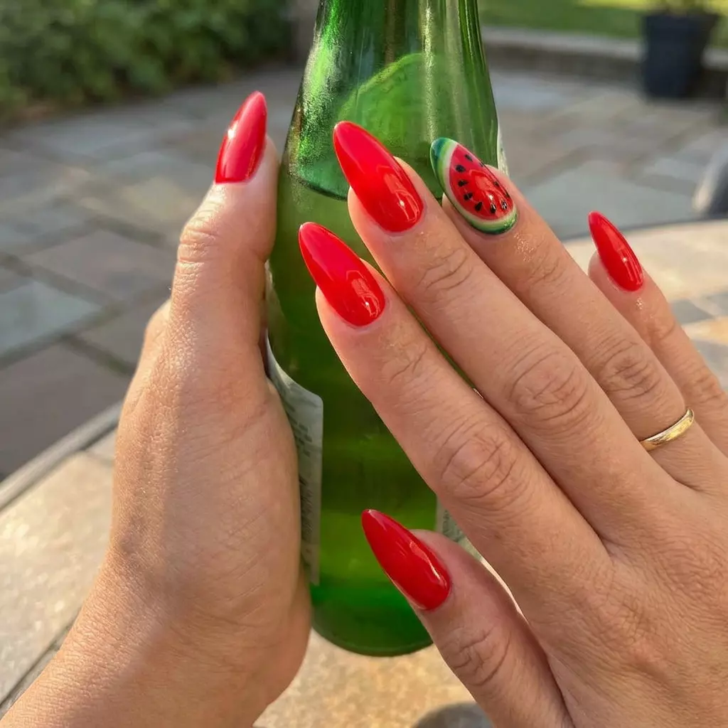Cute summer nails 2026: Watermelon Slice Stiletto Sparkle nails for vacations and parties. Bright red with art.