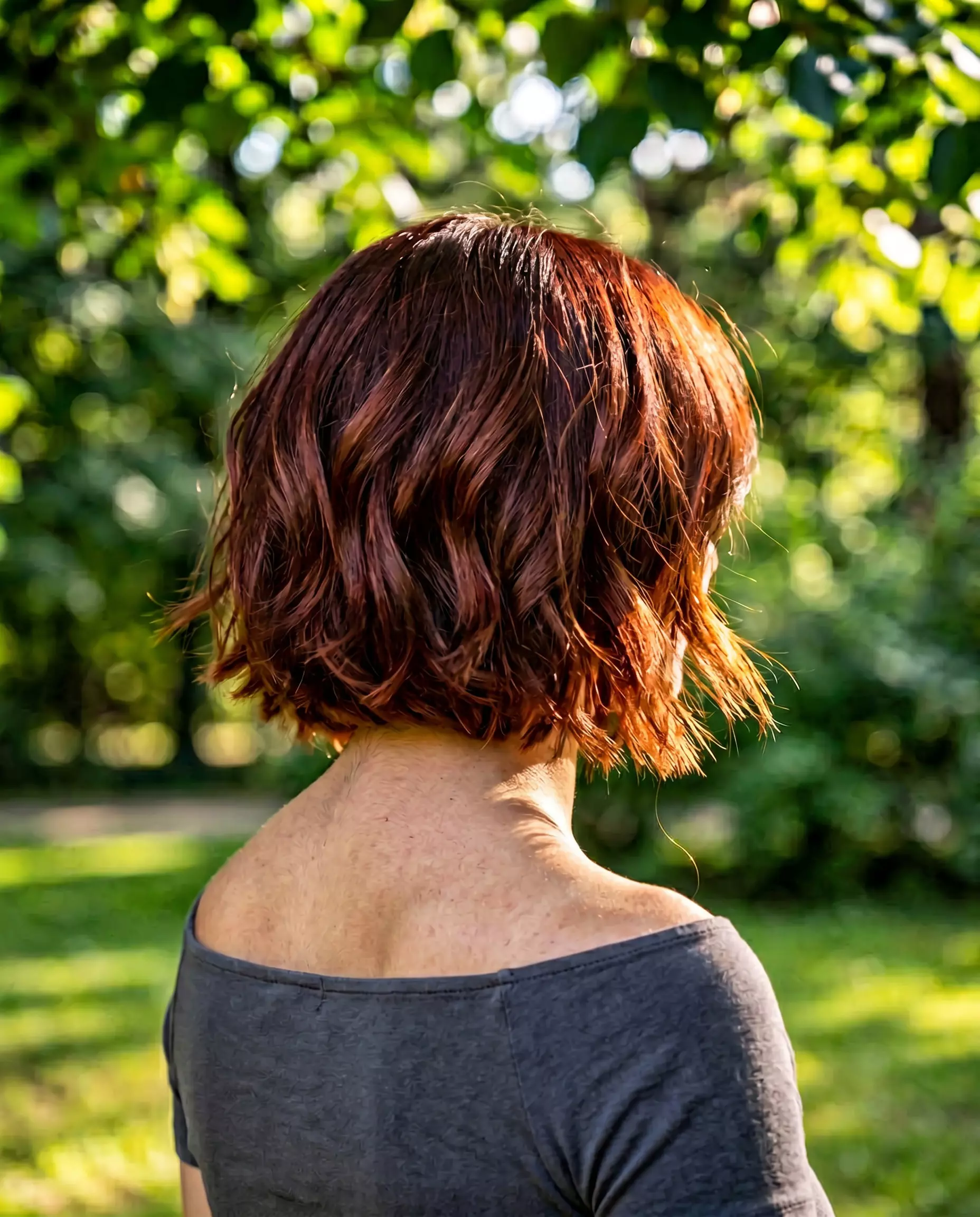 chin-length textured bob haircut with deep auburn for summer 2026