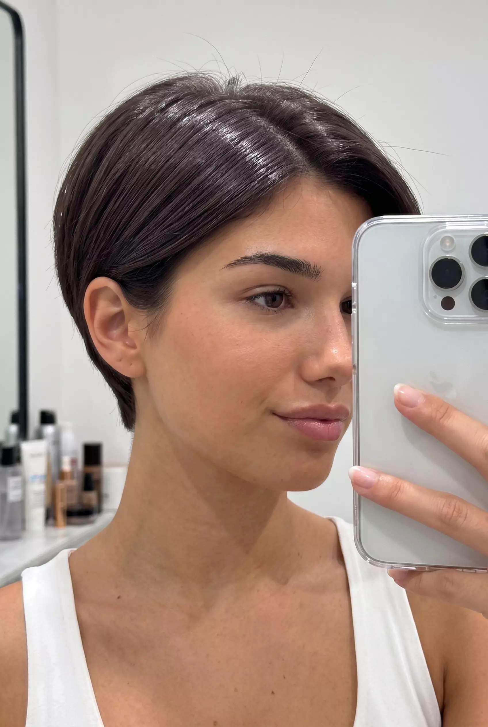 Espresso Brown Pixie 2026: Glossy & Minimalist short espresso brown pixie cut with clear gloss, sculpted shape, no bangs — minimalist chic look