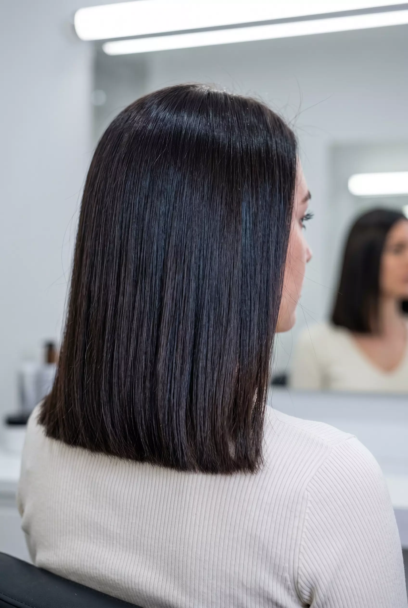 shoulder-length espresso brown lob with blue-black undertones, blunt cut, for professional events