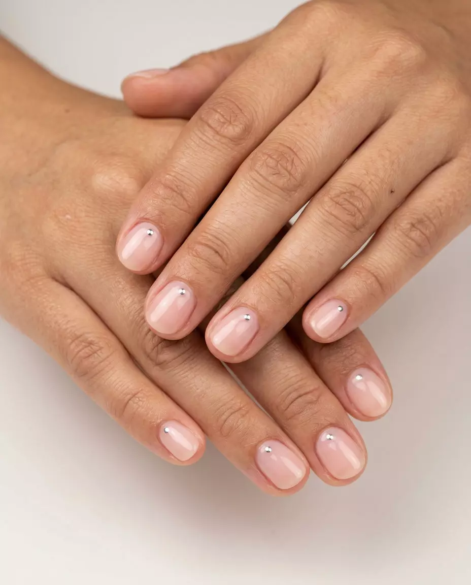 Minimalist Chrome Dot Manicure 2026 Minimalist chrome dot accent manicure, sheer pink base with silver dots. June manicure ideas - summer trends 2026.