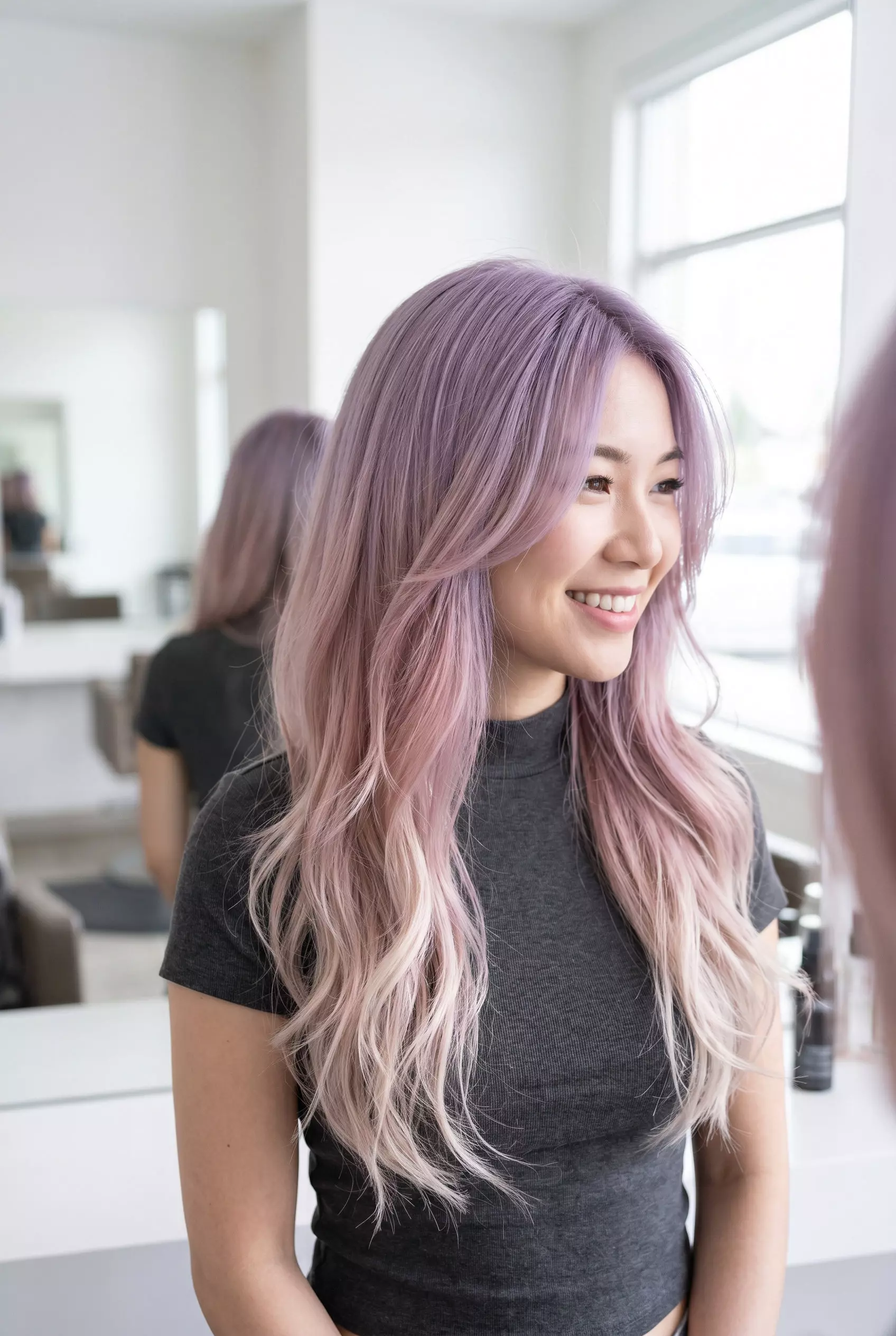 long lavender to dusty rose ombre with flowing layers and wispy face-framing pieces for summer