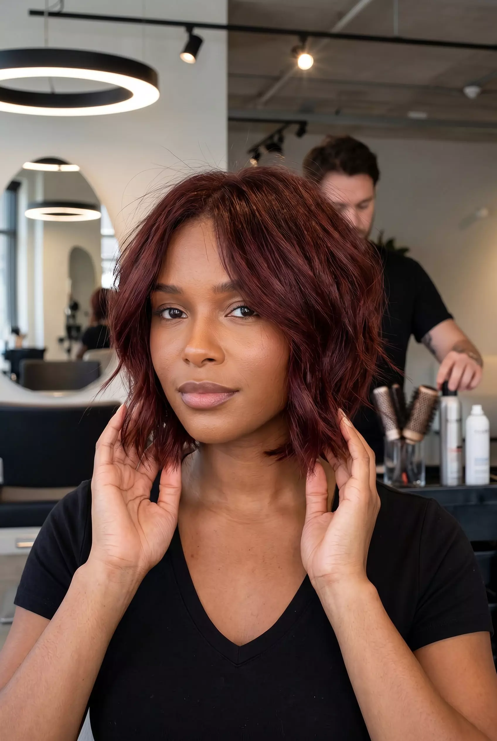 chin-length textured bob haircut with deep mahogany red and choppy layers for a dramatic look