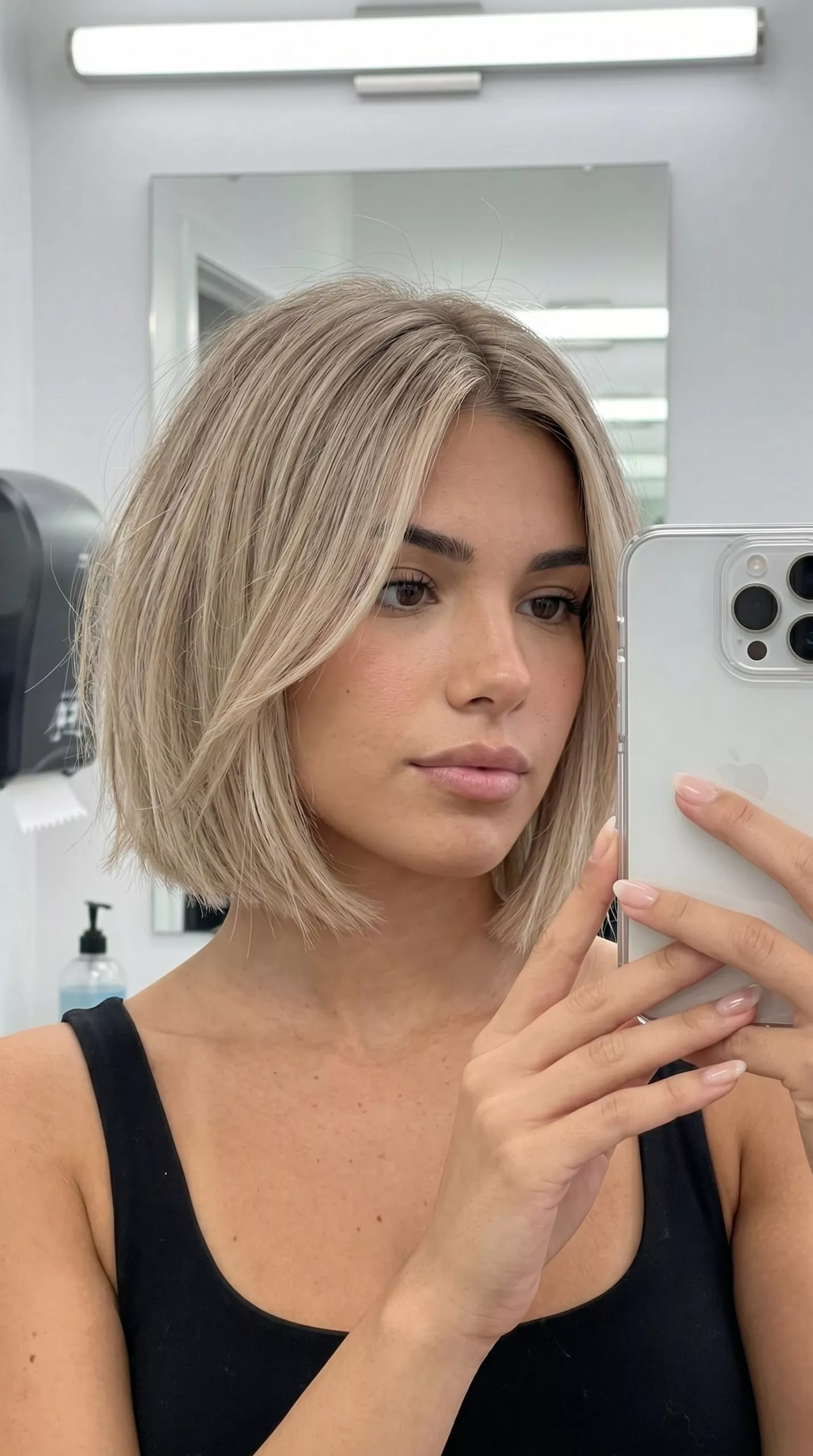 chin-length textured bob haircut with neutral beige blonde, subtle internal layers for summer 2026
