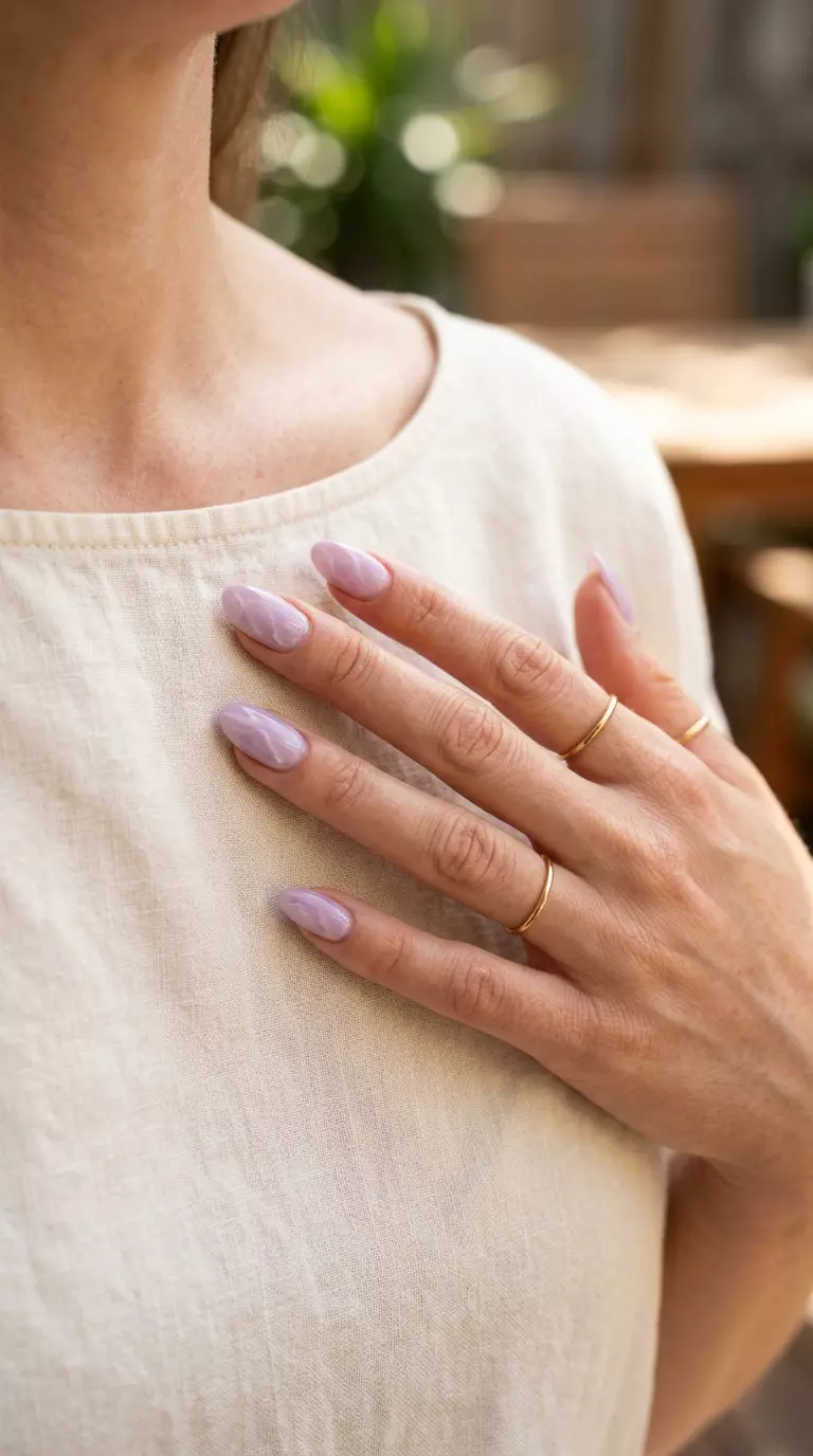 Milky Lilac Marble Oval Summer Nails 2026 Milky lilac marble effect oval summer nails 2026 for all skin tones, elegant for weddings and special events.