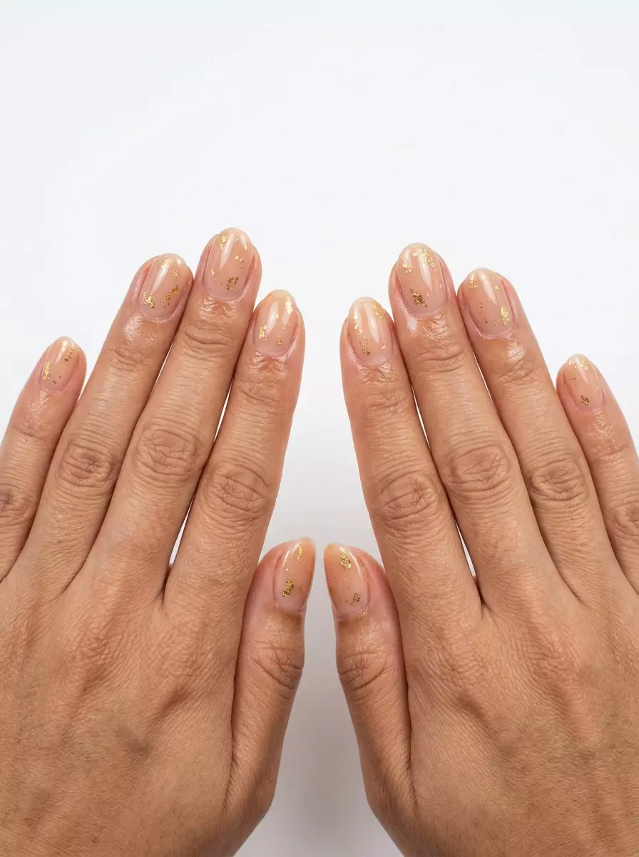 Golden Hour Nude Flakes Short Oval Nails 2026 Glamorous warm nude short oval nails with gold flakes for daily, casual, date night, summer evenings. Short oval summer nails 2026.