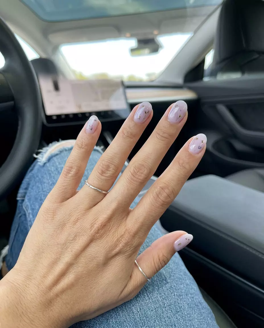 Short round summer nails 2026: Lavender milk bath with embedded pastel floral accents for a romantic event.