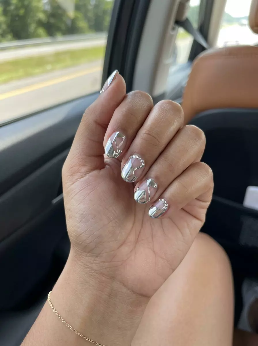Short round summer nails 2026 with silver chrome geometric negative space for edgy, futuristic party looks.