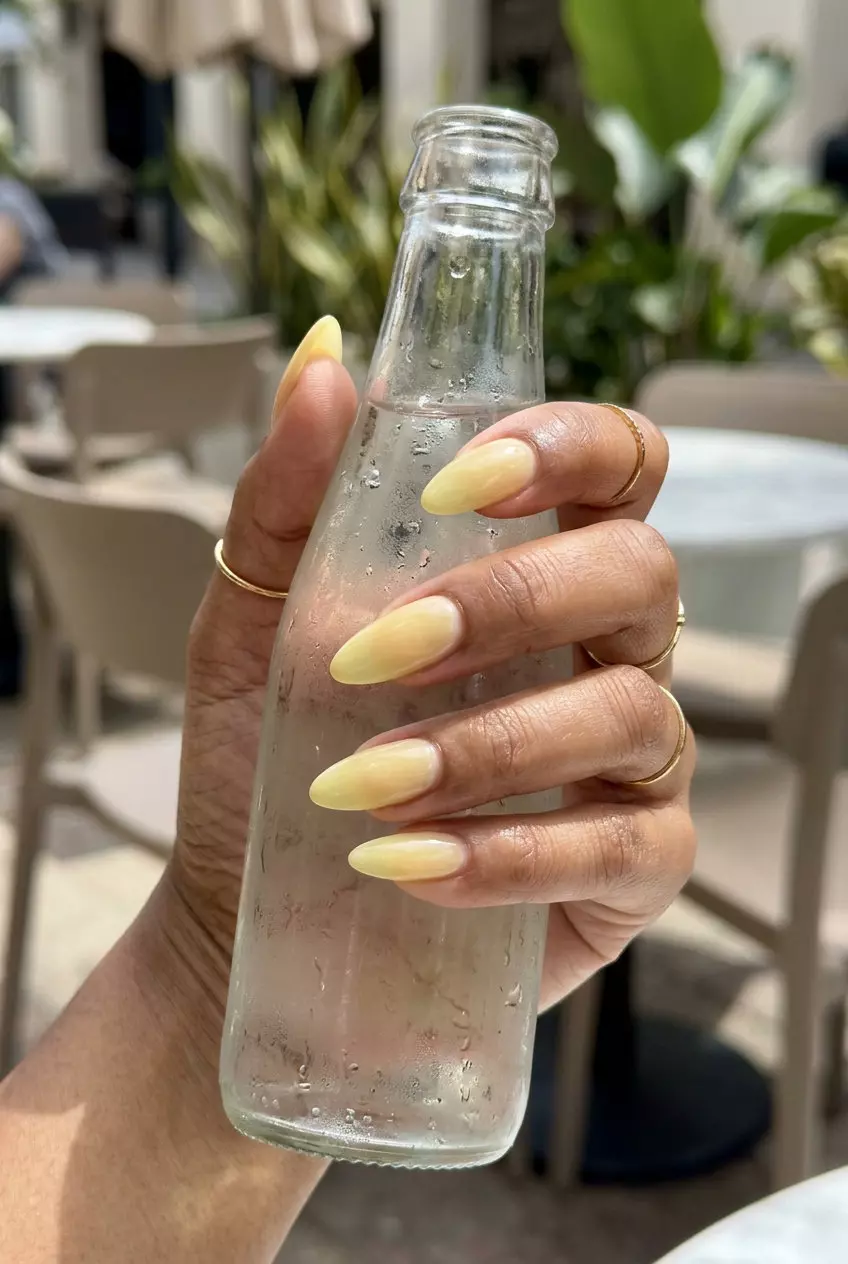 Lemon Drop Summer Almond Nails 2026 Elegant pale yellow jelly acrylic nails with a sheer finish for simple summer acrylic nail designs 2026.