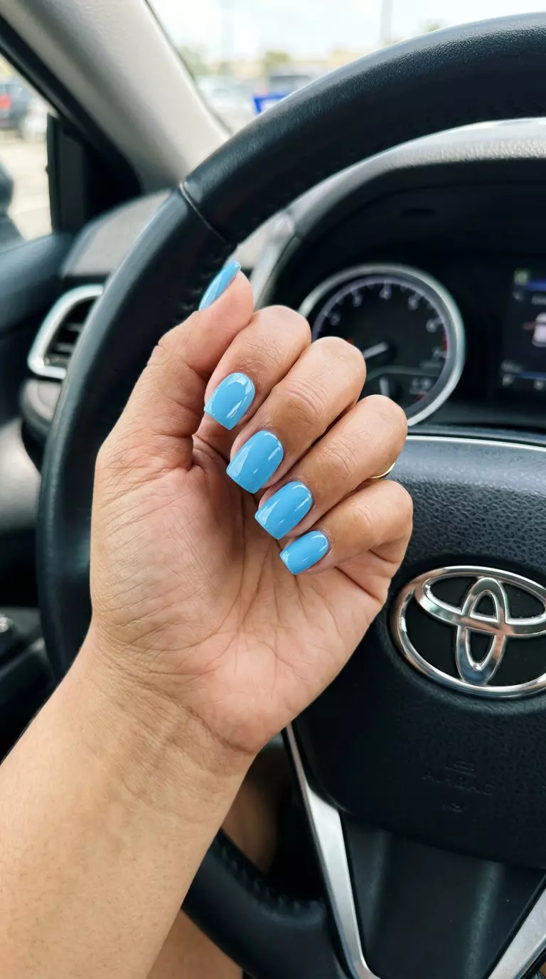 Sky Blue Solid Glossy | Bright Summer Nails 2026 Sky Blue Solid Glossy: Playful medium acrylic nails in opaque sky blue with a high-gloss finish for summer events. Simple summer acrylic nail designs 2026.