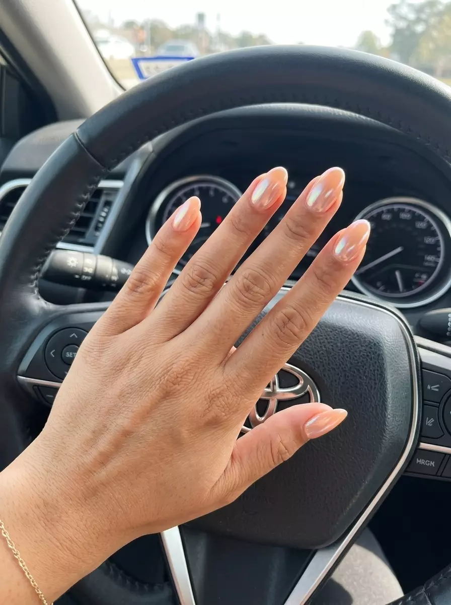 Soft Peach Glazed Donut Oval Nails 2026: Vacation Glam Soft Peach Glazed Donut Oval nails: glamorous, chic look with pearlescent shimmer for summer vacation 2026.