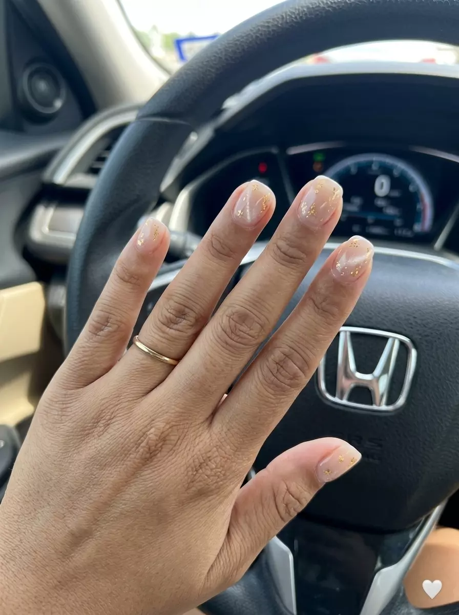 Gold Flake Cat Eye Nude Nails 2026 Gold Flake Cat Eye Nude nails for summer 2026: Chic nude nails with scattered gold foil and diffused magnetic shimmer.
