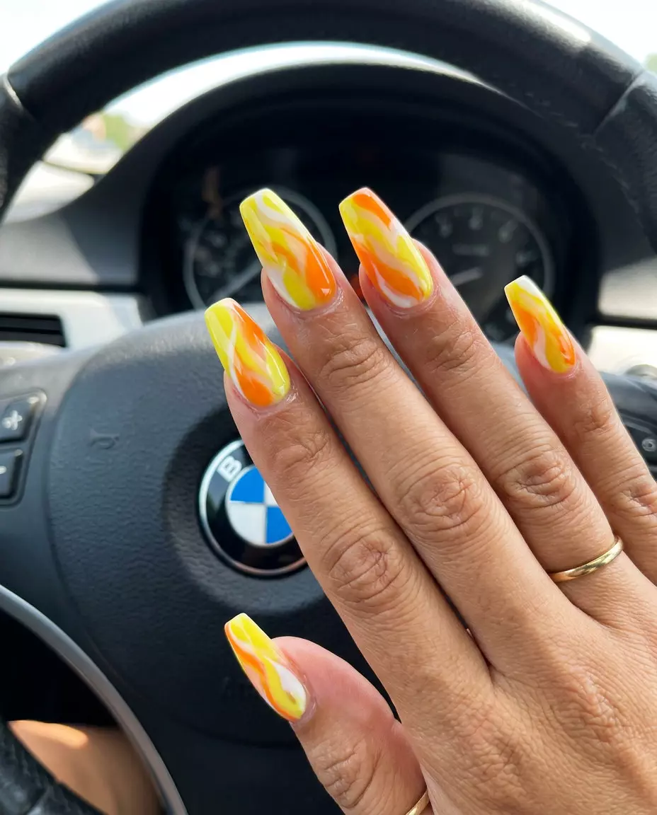 Summer Citrus Nail Art 2026: Abstract Citrus Swirls Artistic Abstract Citrus Swirls nails for summer citrus nail art 2026. Bohemian party nails in yellow, orange, and white.