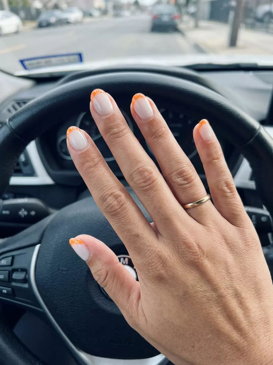 Summer Citrus Nail Art 2026: Orange Slice Micro French Playful Orange Slice Micro French nails for summer citrus nail art 2026. Cheery party nails with white and orange tips.