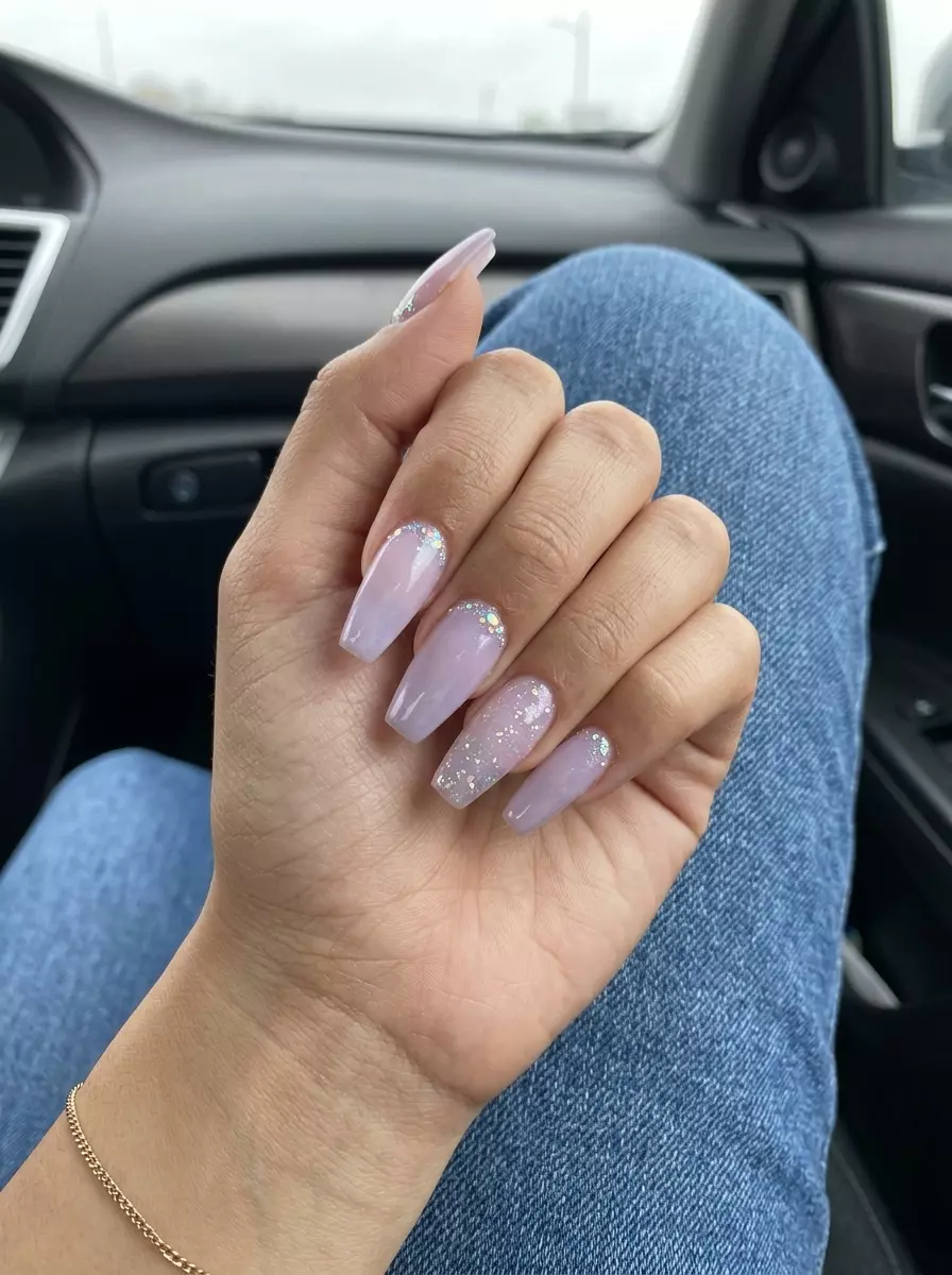 Dreamy long coffin nails in milky lavender with iridescent glitter accents for summer glitter nails 2026.