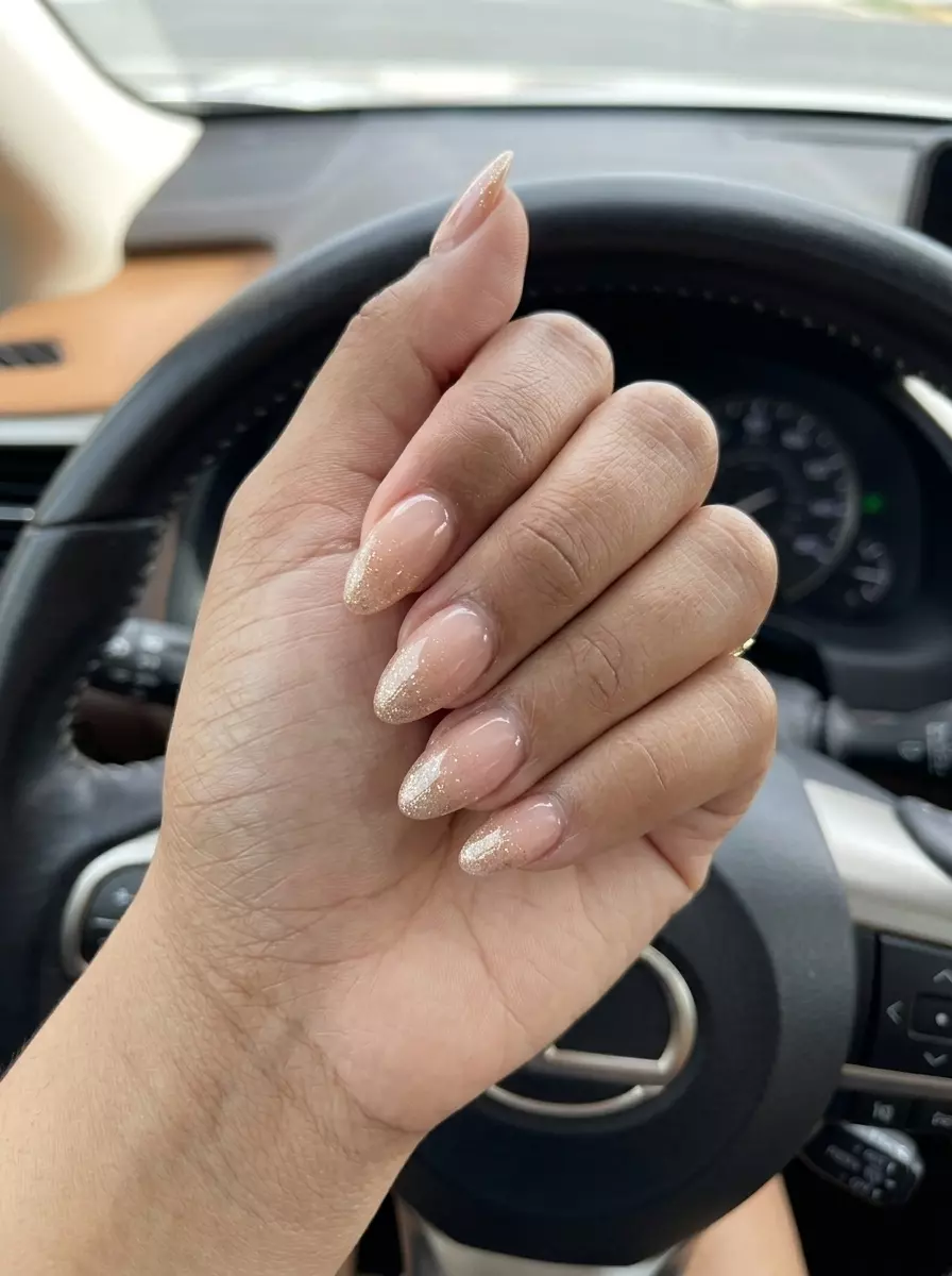 Nude pink nails with gold glitter overlay for summer glitter nails 2026 work outfits.