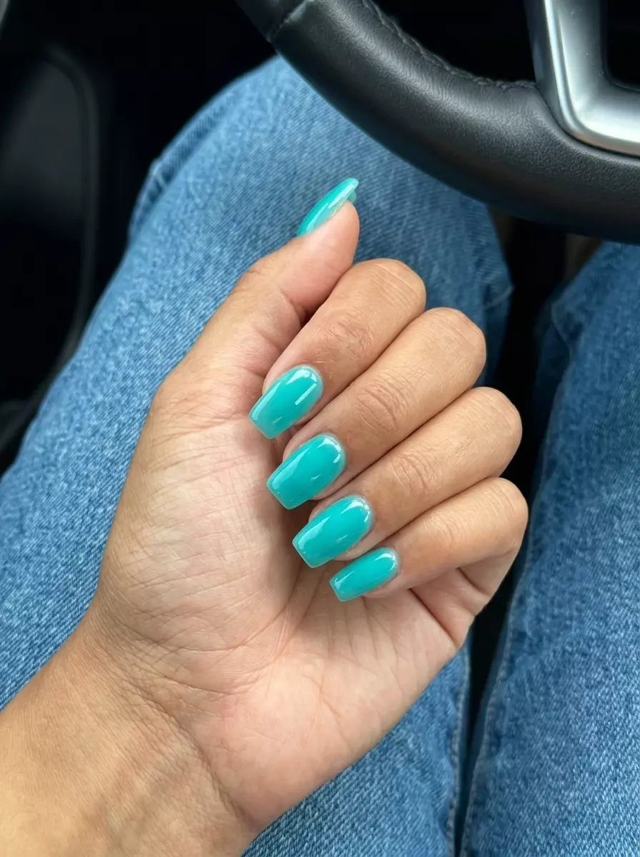 Vibrant aqua jelly nails for summer holiday nails 2026, perfect for beach vacation and festivals. Short coffin shape with glossy finish.