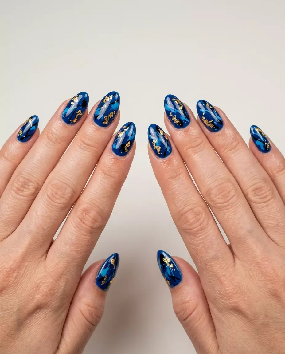 Blue Gold Foil Almond: Date Night & Event Nails 2026 Abstract Blue and Gold Foil Almond: Sophisticated summer inspired nails 2026 with deep blue and gold foil.
