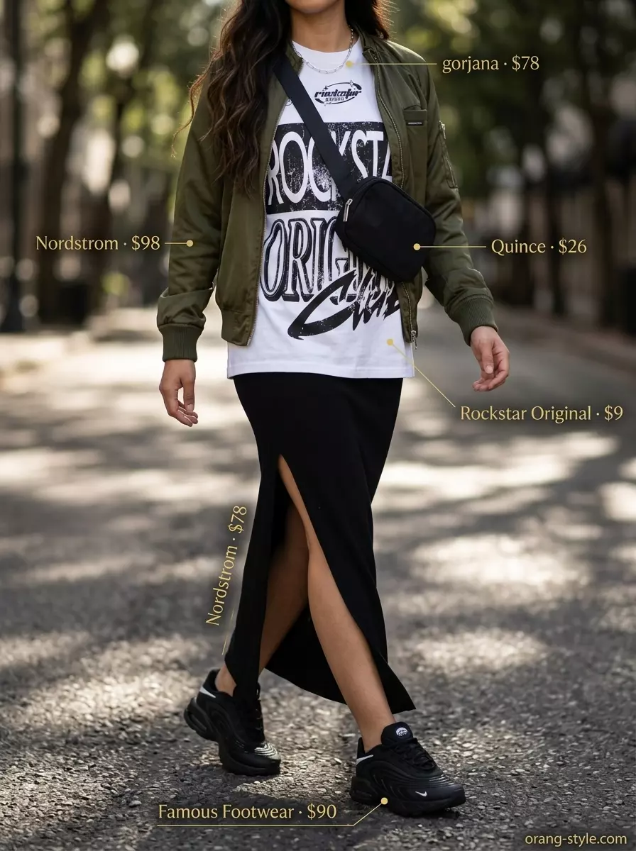 Urban Explorer summer maxi skirt and sneakers outfit 2026: black skirt, graphic tee, bomber jacket, crossbody bag.