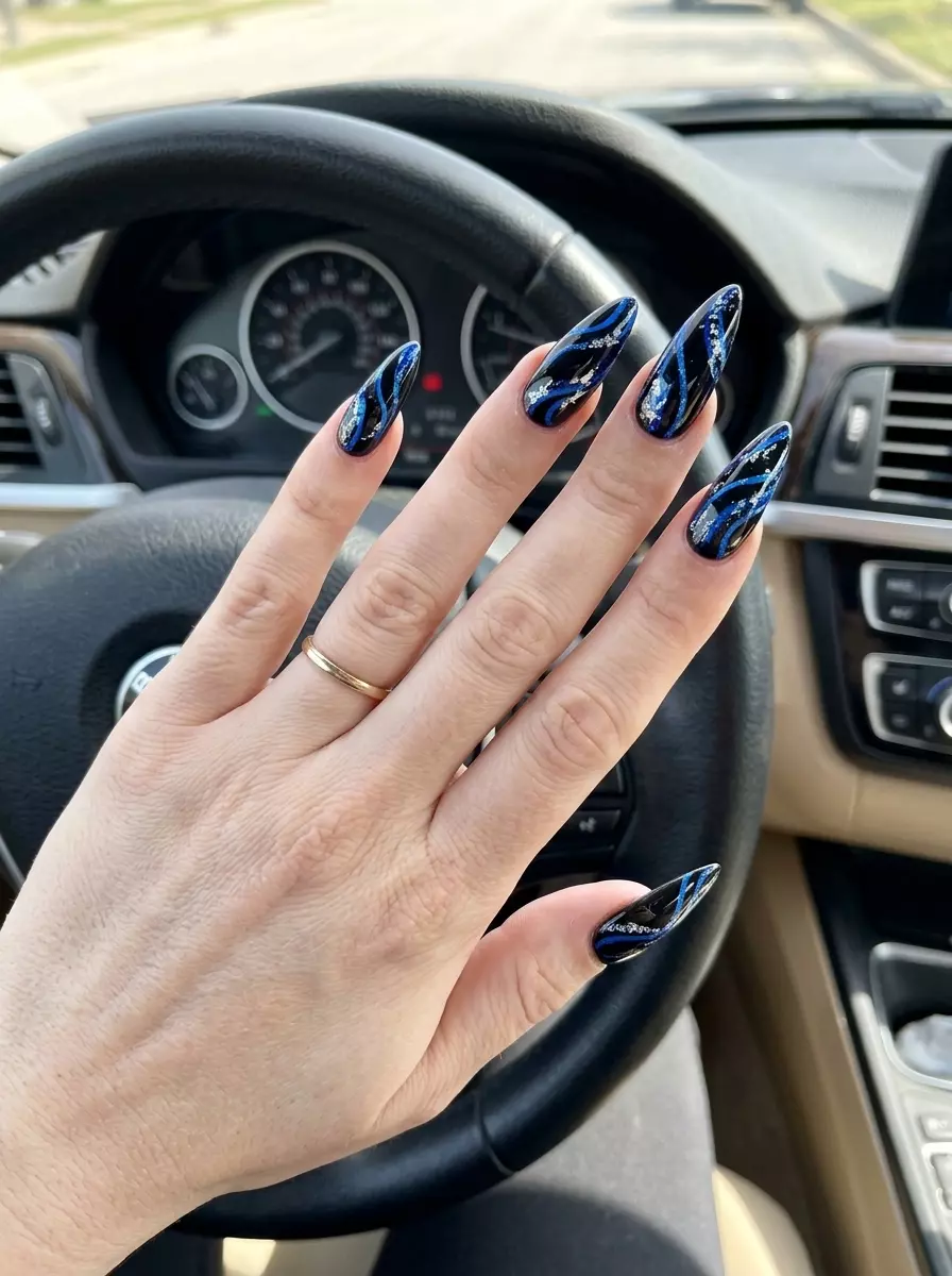 Edgy electric blue abstract swirls stiletto nails for summer nail art 2026. Perfect for night outs and festivals.