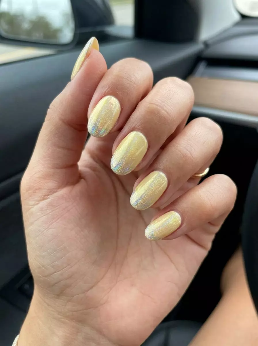 Butter yellow nails with holographic accent for summer nail art 2026. Whimsical, elegant, perfect for brunch and casual days.