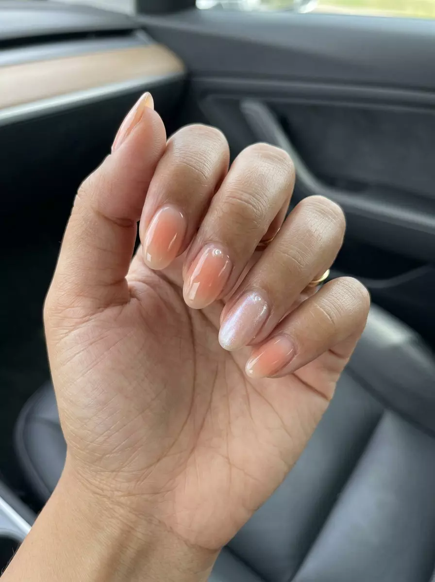 Milky Peach Aura: Ethereal summer nail colors 2026 for vacation. Soft peach gradient & shimmer.