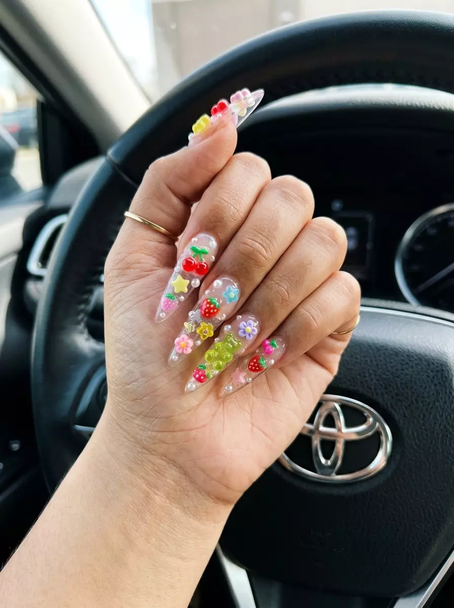 Playful Summer Nail Manicure Ideas 2026 Clear stiletto nails with vibrant multicolor jelly charms for a playful summer nail manicure idea 2026. Festival, party style.