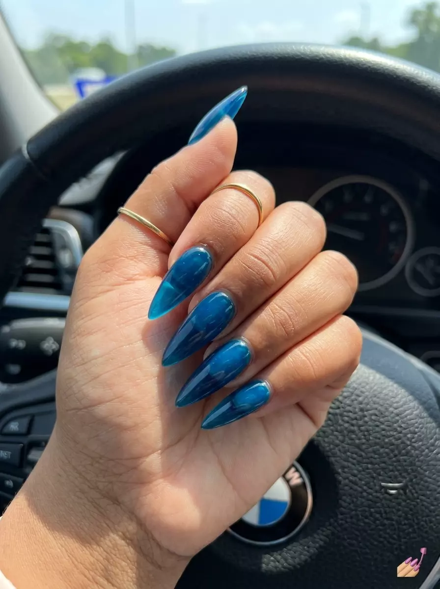 Deep Sea Jelly Stiletto Nails 2026 Crystal clear blue jelly stiletto nails for summer nails beach vibes 2026. Edgy, bold party look.