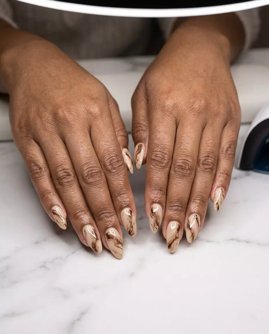 Chocolate Brown Marble Nails 2026 Luxury Chocolate Brown Marble nails for summer 2026: rich brown and beige with gold veins.
