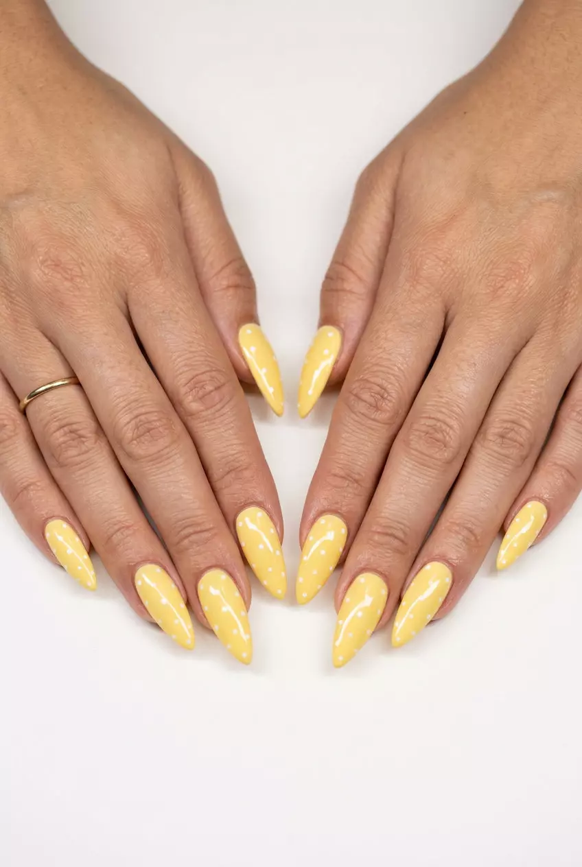 Butter Yellow Dot Stiletto Nails 2026 Playful butter yellow stiletto nails with white dots for festivals. Summer nails yellow 2026.