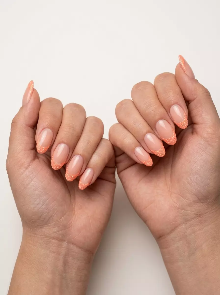 Sparkling Peach Glitter French Nails 2026 Sparkling peach glitter French tip nails for a playful, festive look. Summer peach nails 2026.