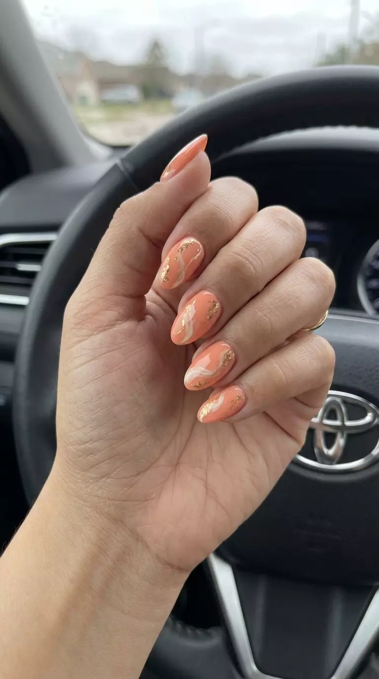 Peachy Swirl Abstract Nails 2026 Peachy swirl abstract nails for summer vacation and casual chic. Bohemian, artistic look with gold accents. Summer peach nails 2026.