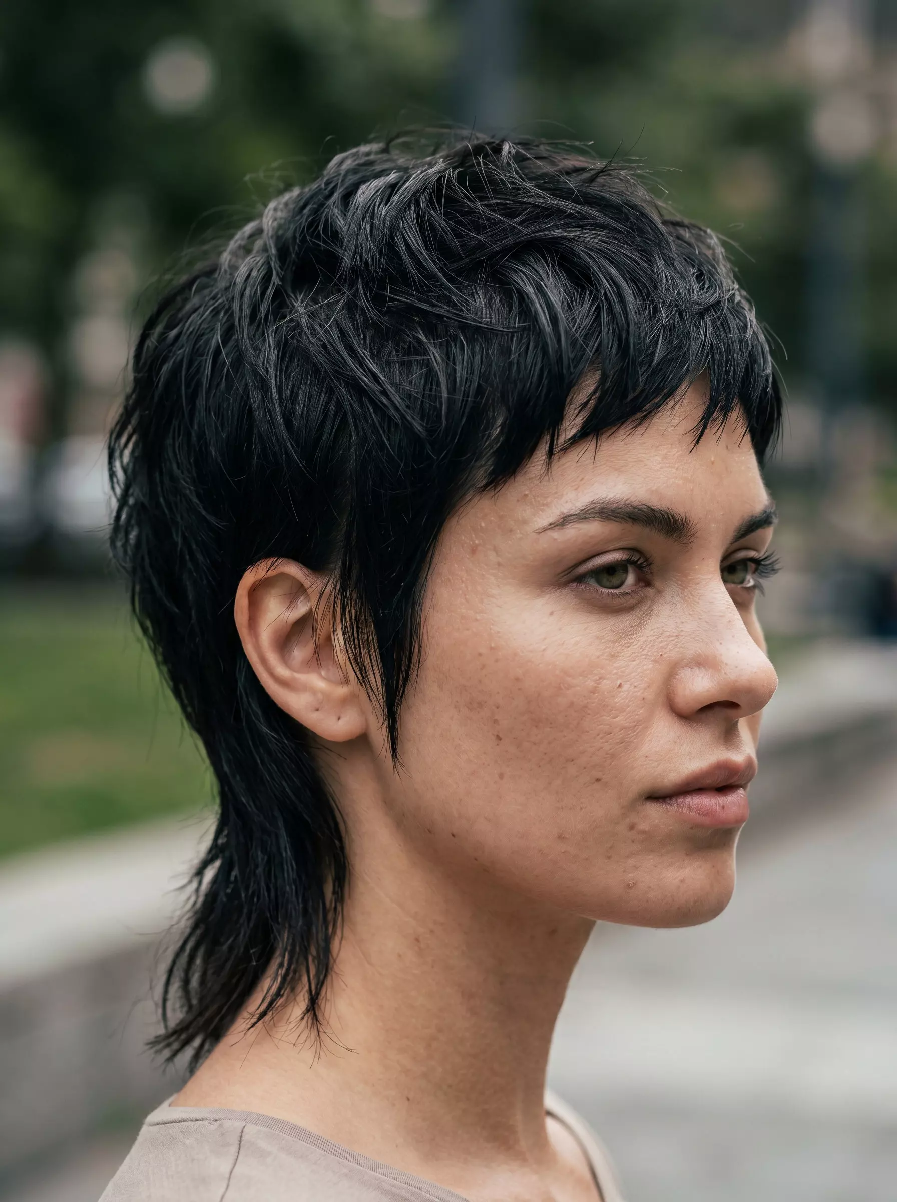 very short pixie mullet haircut with textured layers, longer fringe, and messy tail for summer 2026