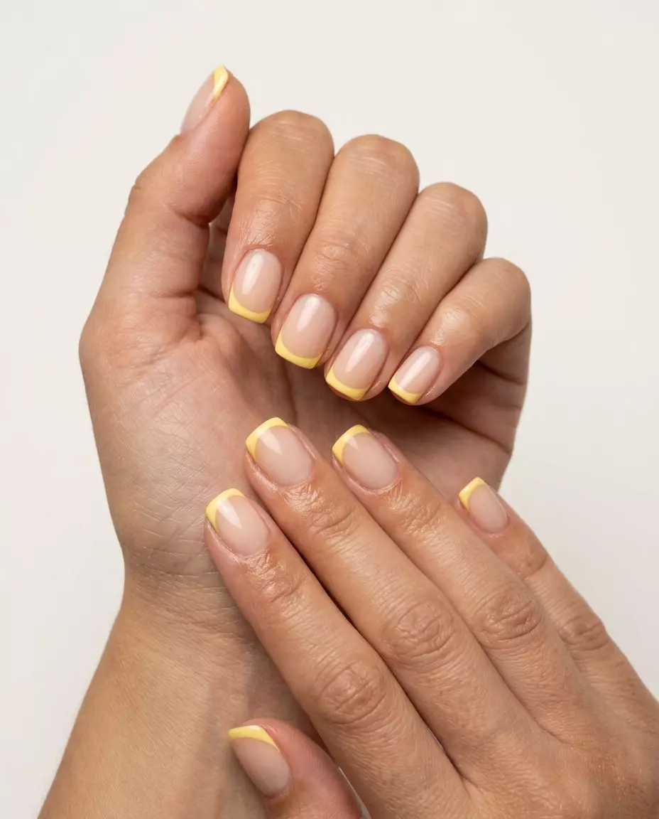 Sunny Reverse French Nails 2026: Casual Summer Style Sunny Reverse French Squoval nails with butter yellow tips for trending summer nails 2026. Casual, daily, picnic outfit.