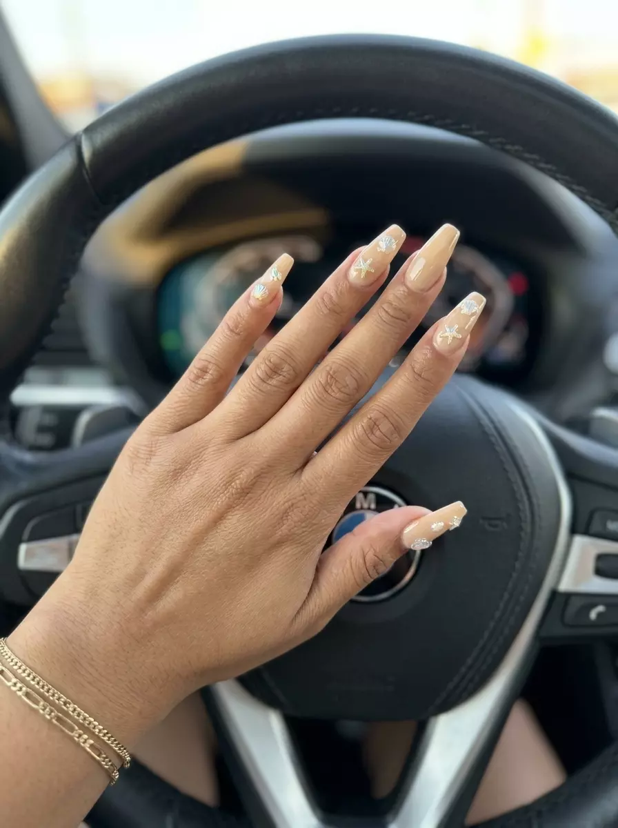 Tropical Nail Designs 2026: 3D Shell Charms Bohemian 3D shell charm coffin nails in sandy beige for vacations and festivals in 2026.