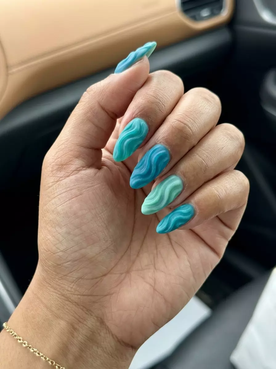 Aqua Texture Water Ripples 2026 Artistic textured water ripple nails in teal, blue, and green for tropical nail designs 2026 evening outs.