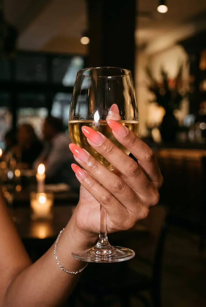 Tropical Nail Designs 2026: Sunset Jelly Ombre Glamorous sunset jelly ombre almond nails in coral and pink, ideal for date nights in 2026.